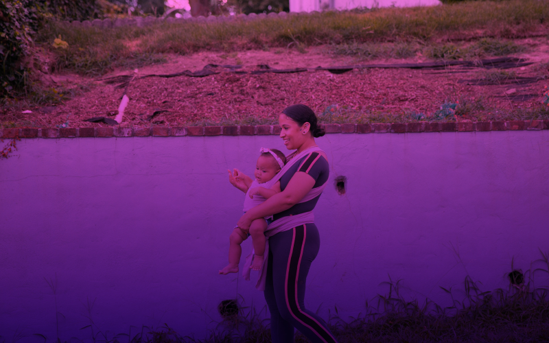 Woman walking with a baby carrier